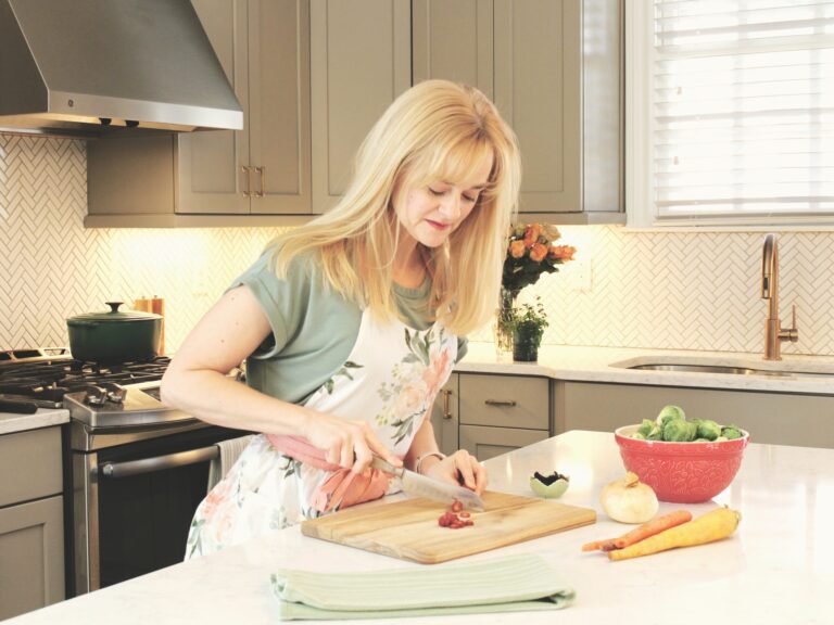 Emily Haygood chopping vegetables in the kitchen