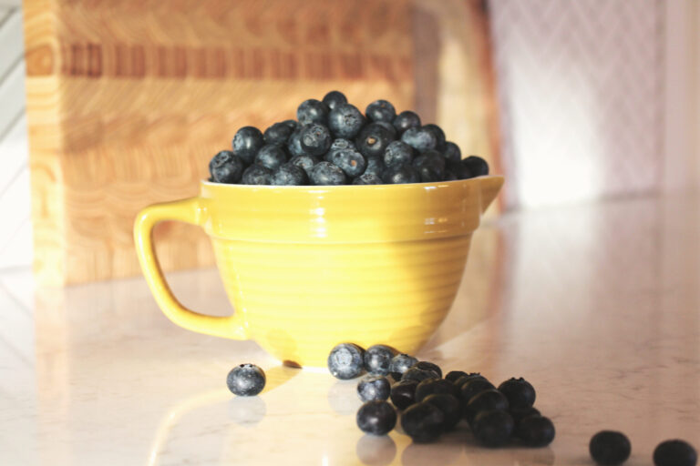 In season Blueberries in yellow porcelain measuring cup